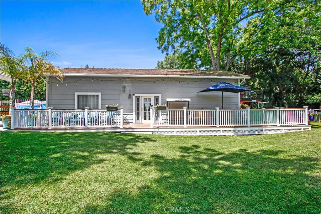Huge garage, with Trex decking, currently used as living space with bedroom, kitchenette, with 1/2 bath and laundry