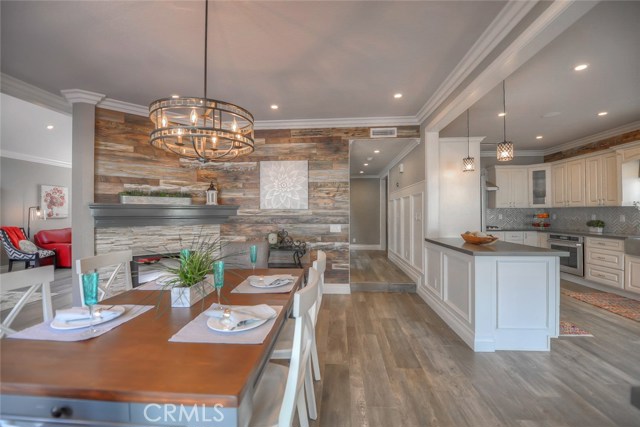 A great view of the dining room, beautifully remodeled kitchen, hall way, and living room.