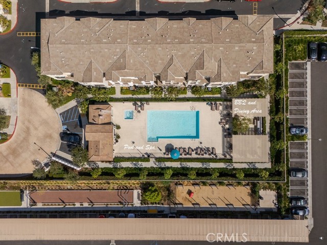luxurious pool and spa area with outdoor kitchen, restrooms, and dining area