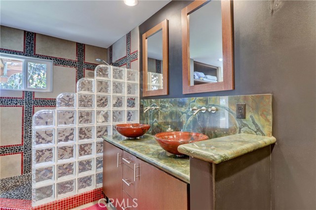 Primary Bath Walk-in Shower with Seat, Glass bowl Double Sinks with Green Marble Countertop & Backsplash