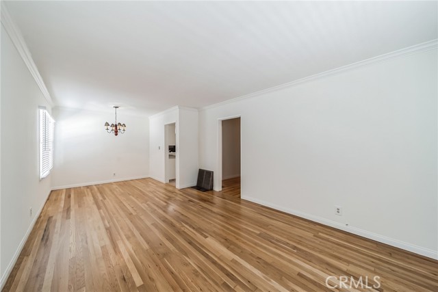 Living room toward dining area and entrance to hall