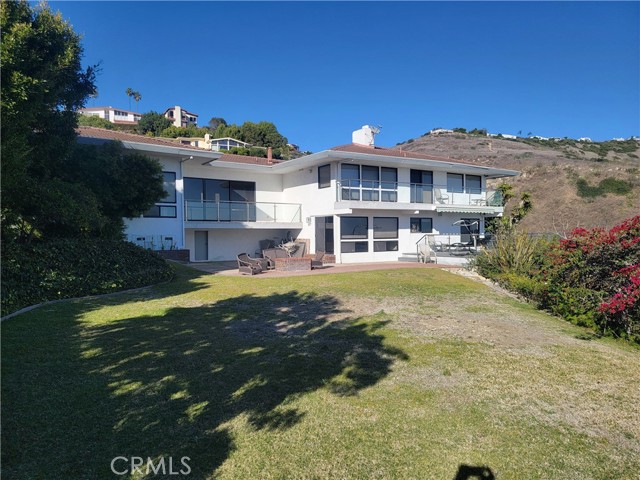 View of backyard with grassy, flat lawn