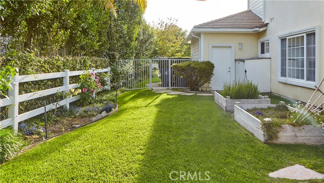 Another grassy area in back yard with raised bed gardens