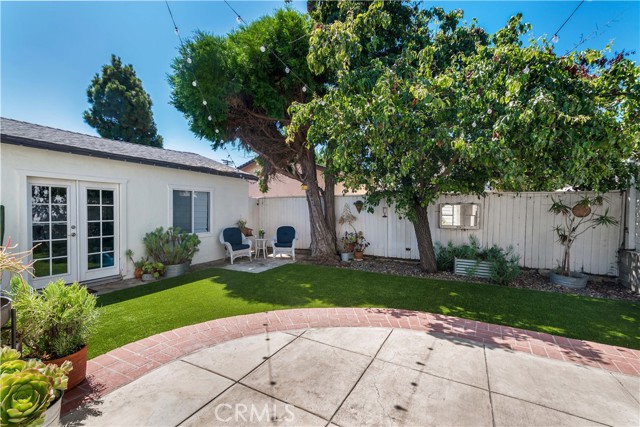 This back yard is so much fun... large concrete patio with steps to grassy are... plenty of room for badminton