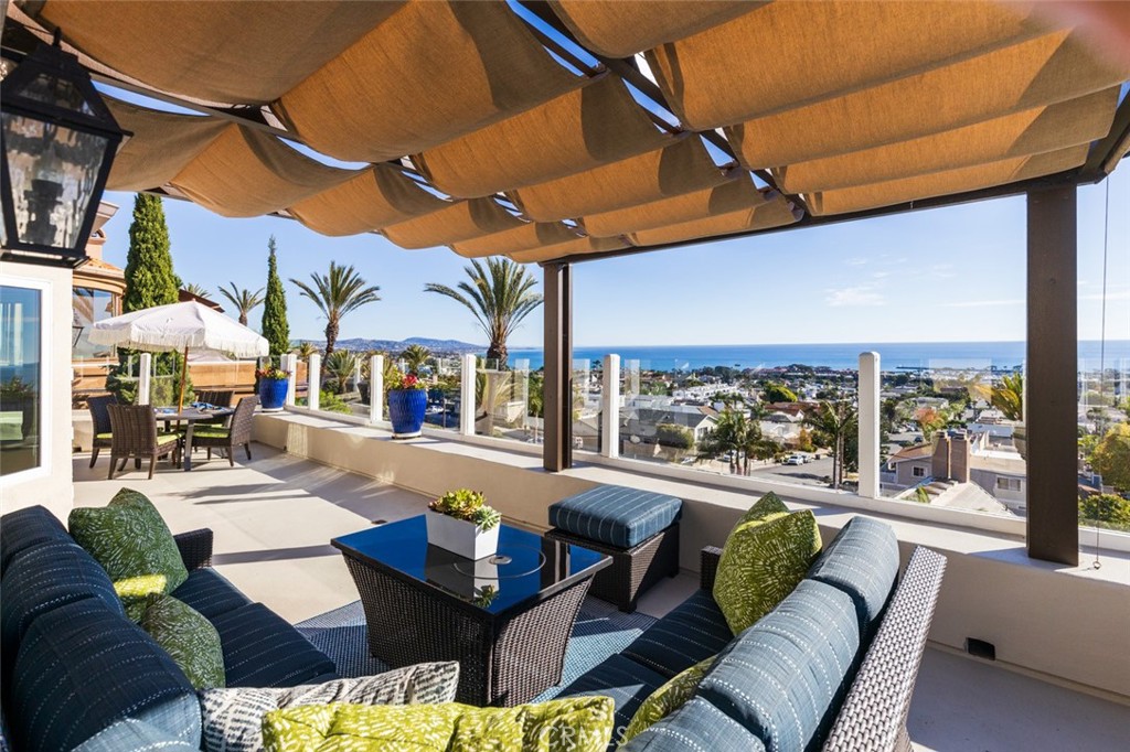 Perched on a coastal hillside in Dana Point, this multi-level updated home offers sweeping views of the vast Pacific Ocean. Nestled at the end of a tranquil cul-de-sac within a gated community, this residence offers the ideal blend of privacy and elegance. With its contemporary design, the residence seamlessly integrates indoor living with outdoor views. Expansive windows flood the interior living space with natural light, highlighting modern finishes and open concept living areas. The heart of this home is the expansive kitchen, equipped with modern appliances and featuring a large center island, great for entertaining guests or enjoying casual meals. The kitchen flows seamlessly into a gracious living area, where large windows allow views along the California coastline. This home boasts five generously sized bedrooms, providing ample space for both you and your guests. The primary suite is a true retreat, offering a private sanctuary with a spa-like ensuite bathroom and walk-in closet. The additional bedrooms are versatile and great for use as guest rooms, offices or exercise spaces, adapting to your needs. One standout feature is the dedicated office space, ideal for those who work from home or desire a private study area. This thoughtful inclusion enhances the functionality of the home, providing a peaceful and productive environment. Head outside into the backyard oasis, where a carefully designed landscape offers a serene escape. Whether you're hosting gatherings, enjoying al fresco dining or simply relaxing in the sunshine, the outdoor space is sure to become a favorite retreat. Living in this gated community ensures a sense of security and exclusivity, allowing residents to enjoy the amenities and serenity of Dana Point. With its prime location at the end of a cul-de-sac, this home provides a peaceful sanctuary, while still being conveniently close to the vibrant coastal lifestyle, shopping, dining and the scenic beauty of Dana Point Harbor.