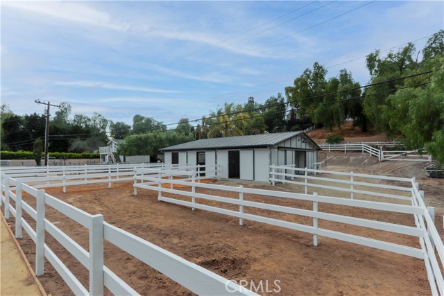 Spacious turnouts for all four horses. Plus, ample space behind the barn for trailer parking, and a utility sink and horse wash area. Directly out the back gate leads you to the Westfield riding ring for convenient exercise and training.