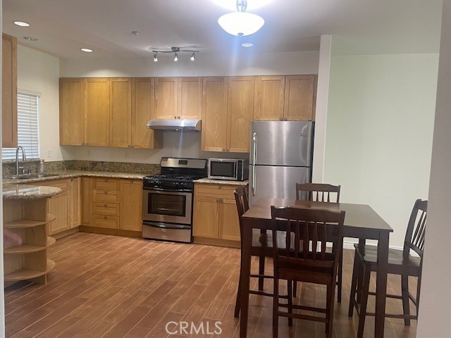 kitchen with gas range, refrigerator and microwave