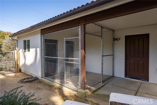 Behind the garage is a built in, covered kennel area.  It could be used for animals or storage.