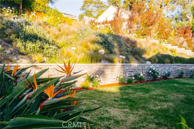 The backyard features charming landscaping and is ready for you to move in.