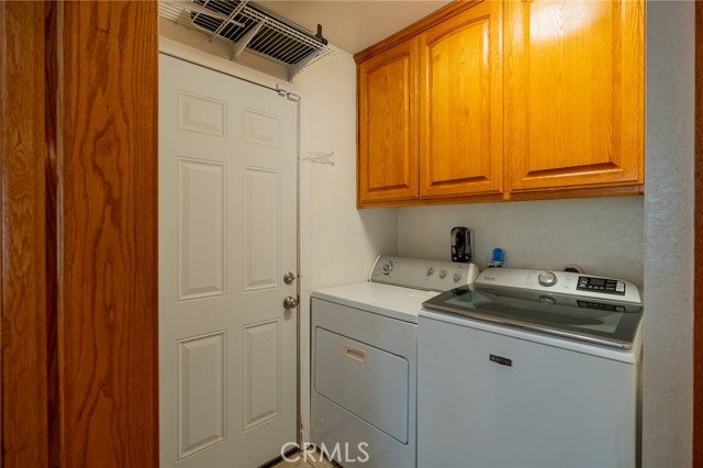  LAUNDRY ROOM OFF KITCHEN WITH SOME ADDITIONAL PANTRY STYLE STORAGE.