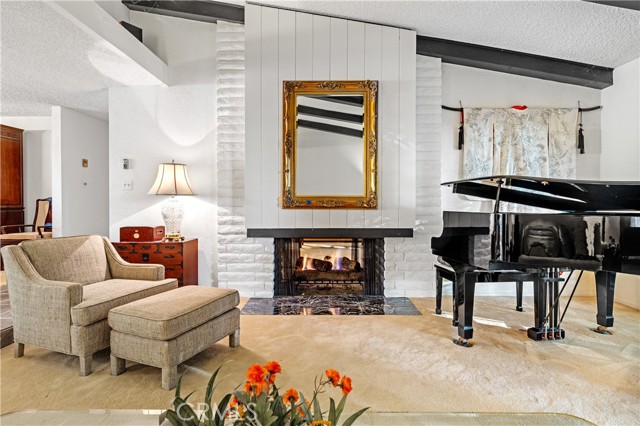 The vaulted ceilings and dramatic fireplace welcomes you in the living room.