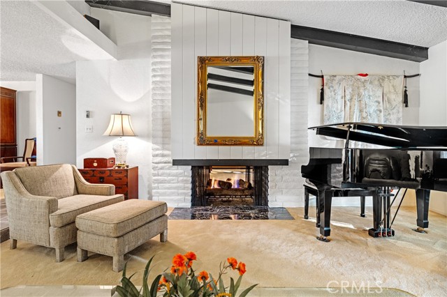 The vaulted ceilings and dramatic fireplace welcomes you in the living room.