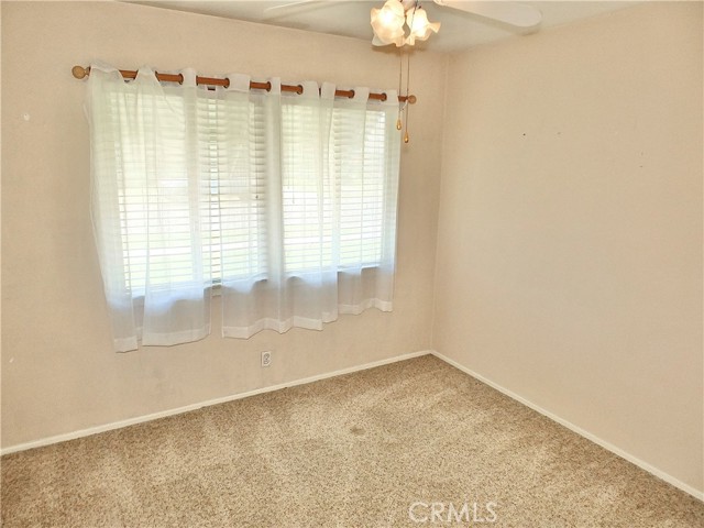 Bedroom 1 - sunny with nice drapes & carpeting