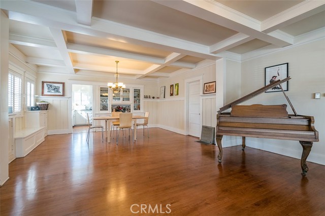 The dining room with the perfect area for a piano adjacent to the living room and fireplace areas all enhanced by original wood flooring.