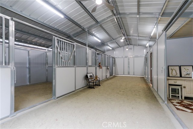 A brand-new, breezeway barn with a 6-stall configuration including 4 paddock stalls with individual turnouts, tack room and cement-floor feed room. App controlled lighting and ventilation, outdoor sink and dedicated horse wash area.