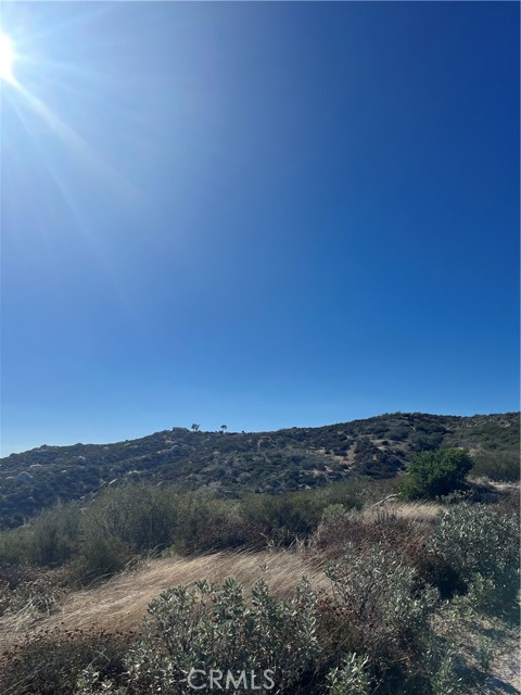 distance view facing W towards property from road coming in