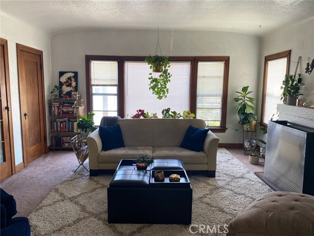 Same living room shows the large picture window and gorgeous wood doors