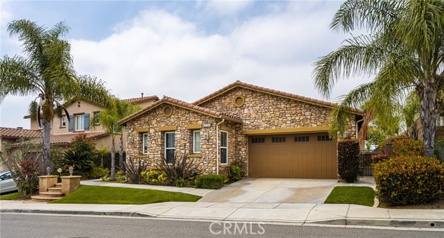 This beautiful home with stone facade in the highly sought after Amalfi Hills is ready for it's new owner. It is a single level home with no steps inside, wide hallways and a beautiful formal living/dining space that greets you when you enter. The kitchen opens to the spacious family room with high ceilings. The kitchen offers brand new GE Profile appliances, and the center island hosts the sink and bar stool seating. There is a dinette that looks out over the yard and and a lovely fireplace for cool evenings. The back patio has a cover and offers hookups for you to design your outdoor kitchen and space for seating. The main bedroom is very spacious and has access to the backyard. The main bathroom offers separate dual sinks, a soaking tub, step in shower and a huge walk in closet. Off the hall, is an ensuite bedroom with lots of windows bringing in the light and it's own walk in closet and bath. You'll find another bath with dual sinks and a tub/shower combo and two more bedrooms along with a guest bath. Marble floors in the entry, family room, kitchen, hall and some of the bedrooms while a few bedrooms have laminate. This beautiful, single level Toll Brothers home is located in the Yorba Linda High School district. Within walking distance to YL High, Trader Joes, parks and walking trails.