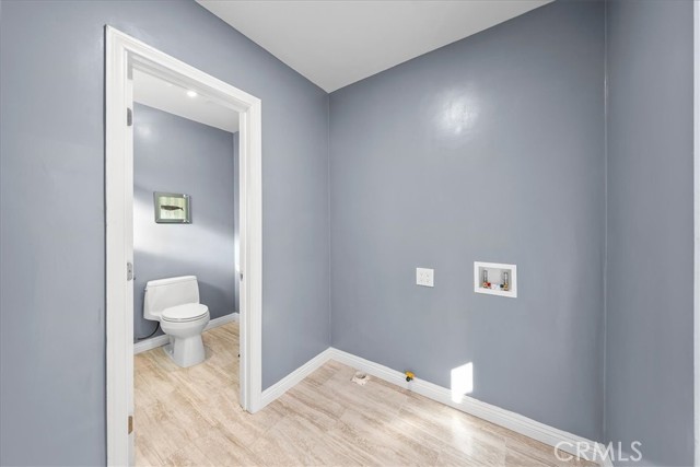 Downstairs laundry room off kitchen.