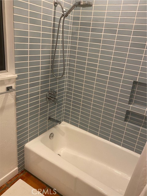Primary bathroom has shower over tub.
