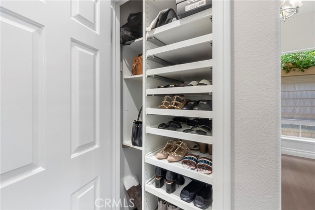 Just off the entry is this custom closet for shoes and handbags