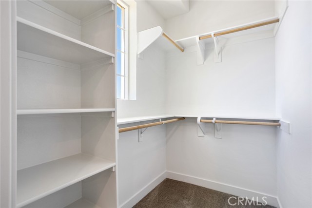 Primary bedroom walk in closet