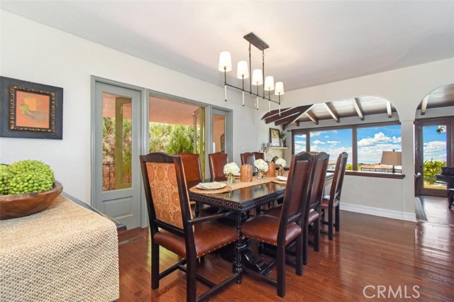 Formal dining with ocean views and French doors to the side yard patio