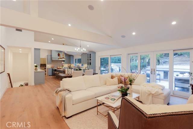 The open living room and it looks into the dining area and kitchen. Convenient access to the 630 square foot tumbled marble deck expands the living space.