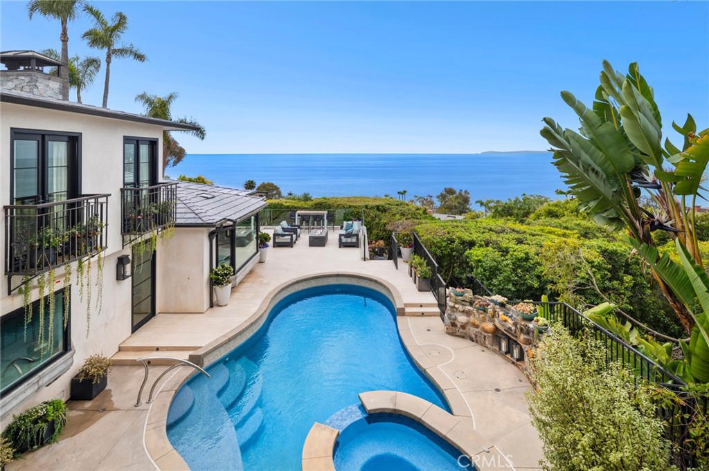 History meets modern luxury at this one-of-a-kind coastal retreat pool home in Laguna Beach with breathtaking ocean views, where an extensive complete renovation was completed in 2020. Offering unparalleled privacy and panoramic coastal vistas from every room, this estate sets a new standard for sophisticated coastal living. Spanning 180º of ocean, Catalina and sunset vistas from its setting at the end of a cul-de-sac that is an easy stroll to Victoria Beach and the Montage Resort. Christened Ciela del Mar–“Heaven of the Sea,” by the original owner/inventor in 1937, the property is meticulously designed and rebuilt with top quality while leaving an irreplaceable uniqueness in certain maintained historical enhancements. A living area defined by white oak beamed ceilings, a wood-burning fireplace and panoramic ocean vistas is the heart of the home. The main room opens to a large limestone patio with a saltwater pool and spa overlooking mesmerizing ocean vistas, all with complete privacy in an ambiance embellished with special lighting, multiple fountains and an outdoor shower. Discover bespoke amenities, including Paul Ferrante custom lighting, a Control4 smart-home system, integrated speakers, advanced security features, whole-house water purification, and custom alder wood doors and windows throughout with custom shades and draperies. An elevator connects all levels, ensuring effortless access throughout the home. Kitchen includes a Wolf range, Sub-Zero refrigerator, Miele dishwasher and quartzite countertops, while the dining room hosts a temperature-controlled wine cellar and opens seamlessly to a protected patio via a full-wall glass pocket door. Enjoy hosting outdoor dinner parties with heaters, an enchanting original stone fireplace, beautiful plantings and a jasmine trellis creating the ideal atmosphere. Perfectly arranged, the floor plan lives like a single-story design with a secondary primary suite and an office on the main level. The top floor reveals a private primary retreat with lofty ceilings, ocean views and a fireplace. The primary bath shines with marble finishes, a luxurious ocean-view steam shower, and a large walk in closet. An attached two-car garage with ample guest parking will make all feel welcome. This meticulously designed home is just moments away from restaurants, galleries, resorts and Laguna Beach's village. Schedule your private tour today and embrace this truly unique property representing the pinnacle of coastal living.