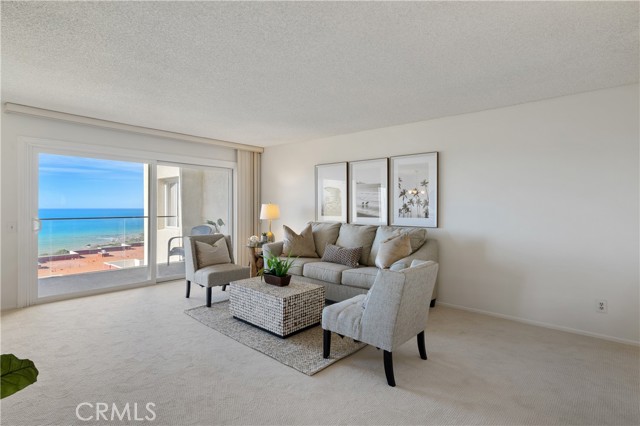 The spacious living room features a warm fireplace, wet bar, and opens to the large ocean view balcony that’s the perfect for everyday indoor-outdoor living, entertaining guests at sunset with the stunning view.