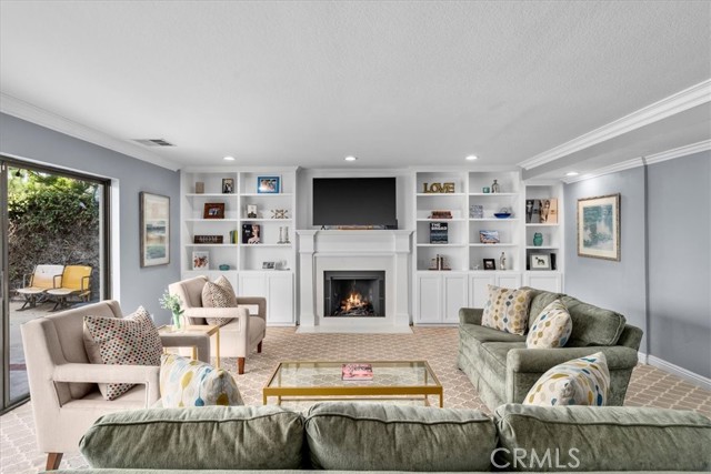 Formal living room with wood burning fireplace.