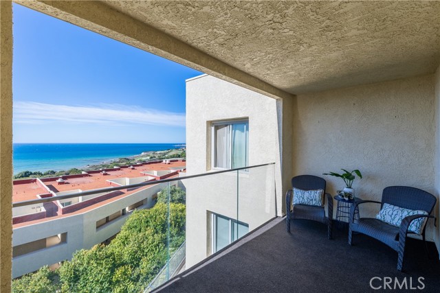 The spacious living room features a warm fireplace, wet bar, and opens to the large ocean view balcony that’s the perfect for everyday indoor-outdoor living, entertaining guests at sunset with the stunning view.