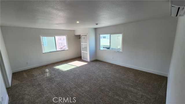 Large living area with lots of light and storage closet