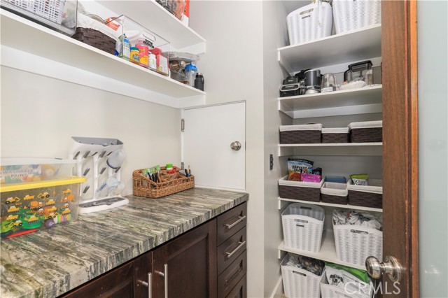 Lots of storage and shelving (behind door) for your walk in pantry needs!