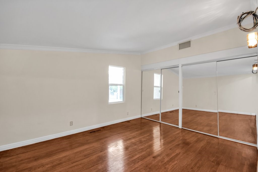 Another bedroom with gleaming hardwood