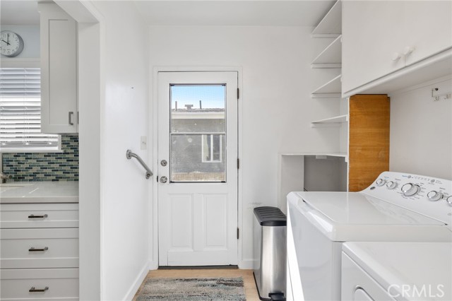 Side door through the inside laundry room opens to a side patio and huge backyard