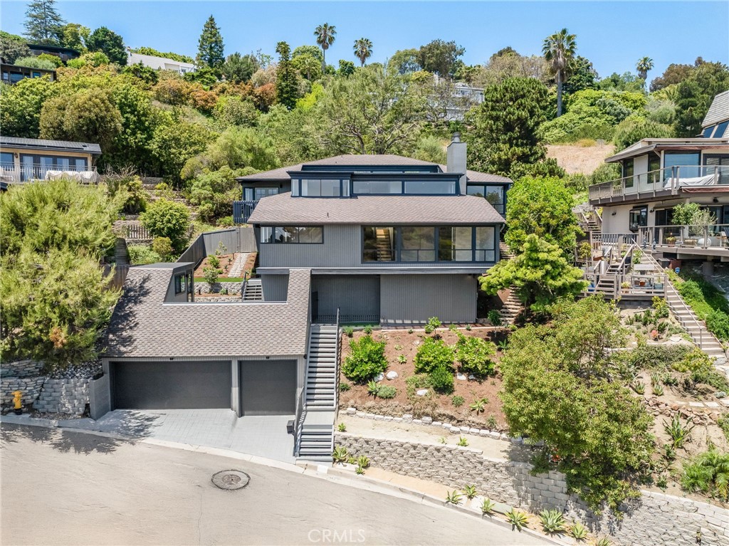 1450 Terrace Way offers a front-row seat to Laguna’s legendary coastline—perched just above the village in the coveted lower Temple Hills neighborhood. With panoramic ocean vistas from all main living spaces, this home is perfectly positioned for sunset dinners, enjoying the ocean breeze, and year-round coastal living. Architecturally distinctive, the residence is located on a peaceful one-way loop street that combines convenience with gracious living. Just moments from Laguna’s vibrant village and pristine beaches, yet away from the hustle and bustle, the location is second to none.
Inside, the home has been meticulously redesigned with modern, high-end finishes, while preserving its unique design elements and creative character. A serene primary retreat offers the perfect place to unwind. Beautifully appointed guest bedrooms make this home ideal for hosting. Most bedrooms offers direct access to the outdoors. Expansive ocean-view decks extend the living space, ideal for enjoying the California coastal lifestyle. Additional features include a rare three-car garage, abundant storage throughout, and a generous bonus space separate from the home—perfect for an art studio, office, media room, or wine cellar. Blending architectural beauty with ultimate comfort and functionality, this residence is a standout in Laguna Beach. 1450 Terrace Way offers a front-row seat to Laguna’s legendary coastline—perched just above the village in the coveted lower Temple Hills neighborhood. With panoramic ocean vistas from all main living spaces, this home is perfectly positioned for sunset dinners, enjoying the ocean breeze, and year-round coastal living. Architecturally distinctive, the residence is located on a peaceful one-way loop street that combines convenience with gracious living. Just moments from Laguna’s vibrant village and pristine beaches, yet away from the hustle and bustle, the location is second to none.
Inside, the home has been meticulously redesigned with modern, high-end finishes, while preserving its unique design elements and creative character. A serene primary retreat offers the perfect place to unwind. Beautifully appointed guest bedrooms make this home ideal for hosting. Most bedrooms offers direct access to the outdoors. Expansive ocean-view decks extend the living space, ideal for enjoying the California coastal lifestyle. Additional features include a rare three-car garage, abundant storage throughout, and a generous bonus space separate from the home—perfect for an art studio, office, media room, or wine cellar. Blending architectural beauty with ultimate comfort and functionality, this residence is a standout in Laguna Beach.