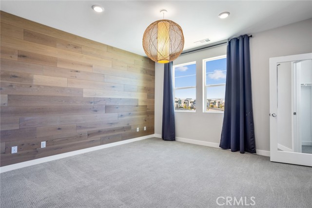 Primary bedroom with feature wall and designer lighting 3rd Floor