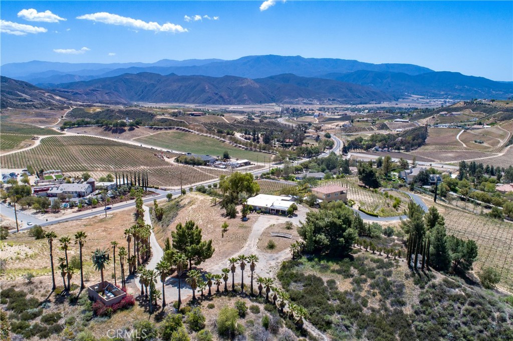 38440 De Portola Road Temecula, California Temecula Wine Country Property w/ Hill Top 360 Degree Views. Prestigious De Portola Road Address, Across from the Leonesse Cellars Winery. In the Direct Path of Future Temecula Wineries. The Property is 9.23 (+/-) Acres and could be developed into a Wine Country Venue or a Private Residence. The Entrance to the Property includes a Palm Tree Lined Concrete Driveway to the Top of the Hill. There is an Existing 3 Bedroom/2 Bath Manufactured Home (w/ Perm Foundation) and a Detached Garage/Workshop on the Pad at the Top of the Hill. Plenty of Space to Expand or Add a New Structure. There is a 2nd Vista Point/Gazebo on the North End of the Hill, Overlooking an Untouched Area of Land for a Future Vineyard. Cellular Tower Provides Monthly Income. No HOA. Low Taxes. An Incredible Opportunity!