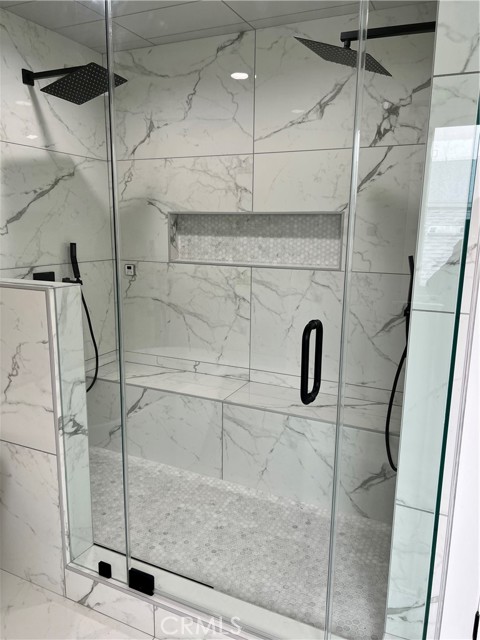 Master shower has dual shower heads and super long bench to rest and relax during your steam shower. Frameless glass doors are treated to be water stain resistant.