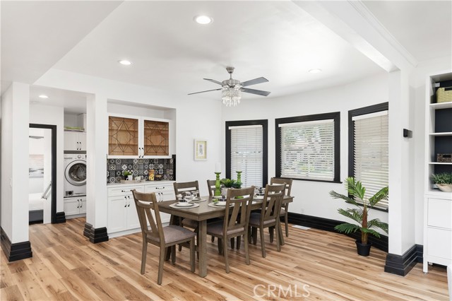 Beyond the dining room, you can see the laundry area and the primary bedroom down 4 steps from the main living area.