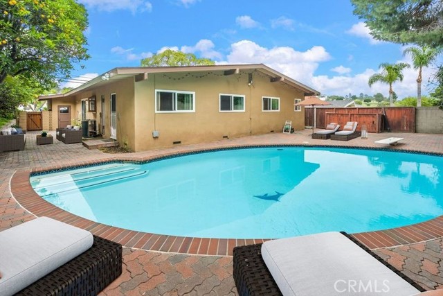 Digitally staged pool and side yard.