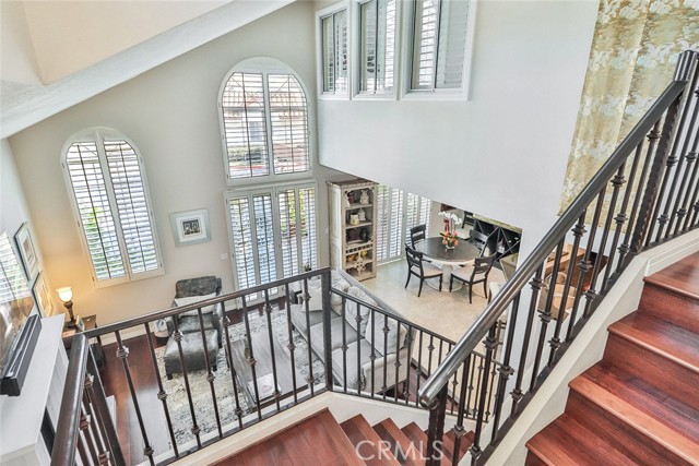 Stair Case looking into living room , high ceilings