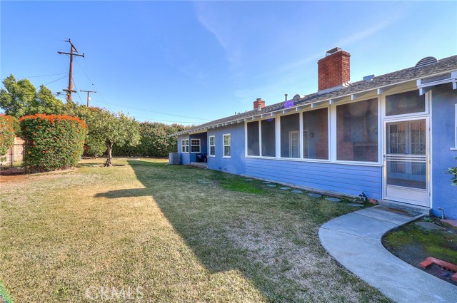 Large back yard with automatic sprinklers.