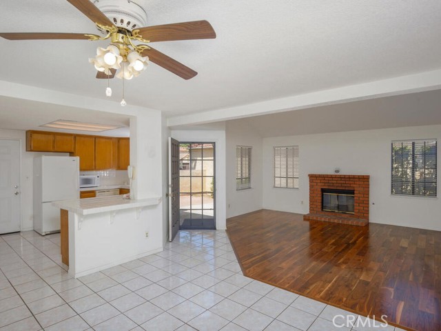 Front entry, Living room with cozy brick fireplace and view of breakfast bar/kitchen.