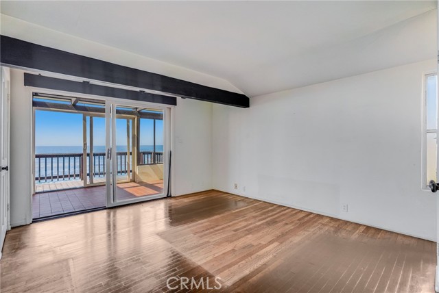 Main level bedroom #1 with ocean view sun room attached.