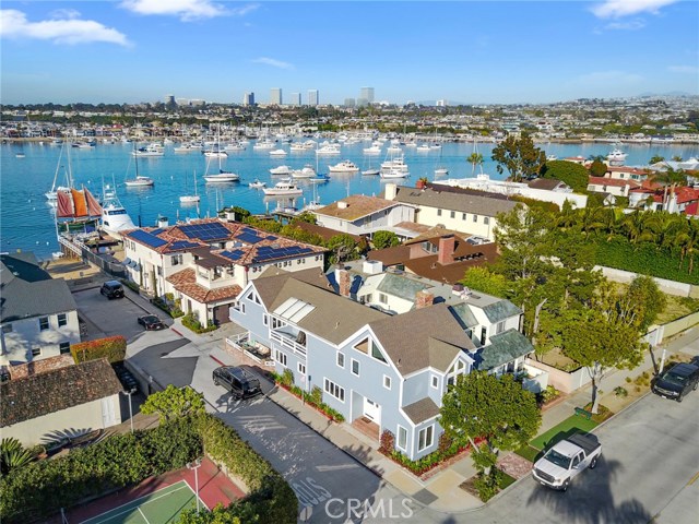 1600 E Balboa Boulevard Newport Beach, California Exceptional opportunity on Balboa's Peninsula Point in Newport Beach. Rare corner lot location just one house from the Bay offers spectacular views of water and beach from both levels. Perfect for entertaining or relaxing, this desirable floorplan includes formal living room with fireplace, dining room, and family room with fireplace, built-ins and wine fridge. Light and bright kitchen has breakfast bar, newer stainless steel appliances, and eating area with French doors that lead to inviting patio area. Upstairs features a master suite with French doors to private balcony with view of the Bay and walk-in closet, a second master suite with full bath, 2 secondary bedrooms, a jack and jill bathroom, and balcony with a view of the Bay. Other amenities include separate laundry room, wood floors, vaulted beam ceilings, new air conditioning, ceiling fans, plantation shutters, mirrored closet doors, skylights, great storage, two car attached garage with direct access to house and newly painted exterior and interior. Ideal for full-time or a beach getaway. Experience coastal living at its finest - swimming, surfing, boating, paddle boarding, biking, and a short walk to beautiful beaches, the Wedge, Ferry, Fun Zone, shopping and restaurants.