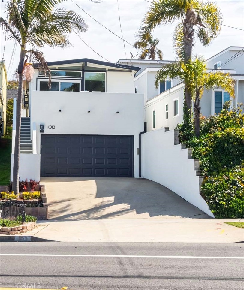 Back on the Market & REDUCED!!!  This delightful, incredibly well maintained one-level-living beach cottage combines coastal charm with many modern updates. White Shiplap ceilings and brand new floors throughout, this sweeter than sweet home features two cozy bedrooms, one bathroom, and a spacious white kitchen with stainless steel appliances and gorgeous granite countertops. There is a lovely dining area plus a two-person counter/bar - perfect for toasting to the sunset directly west and seen through the west wall of glass.  There is a floor- to-ceiling rock wood-burning fireplace for the cool nights, but, by all means, help yourself to the AC if you feel warm.
The west facing front deck is a great spot to catch the sun shining on the ocean and the back private brick patio is a great place for the new fire pit.
Freshly painted inside and out, this home also showcases beautifully reworked landscaping and up-cycled beveled glass exterior light fixtures enhancing its curb appeal. A two-car garage is tucked underneath leaving more parking space on the driveway. Just a short walk to Trader Joe's and Pier Avenue for shopping, dining, and the best of beach living.
