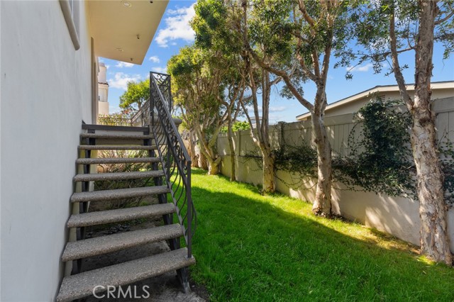 Private rear enclosed yard is accessed from the front of the townhome and the lower balcony.