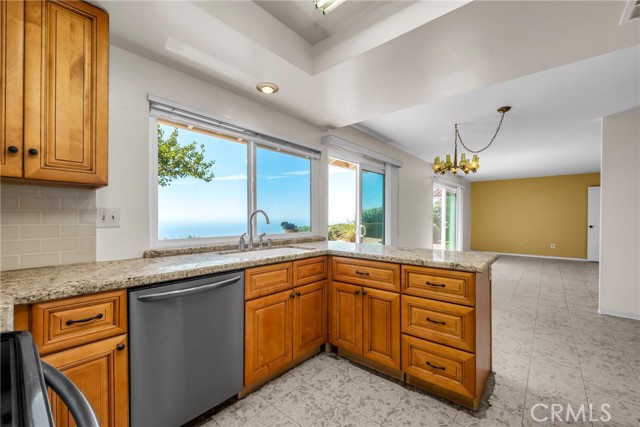 Updated kitchen looks into family room and oh, that view!